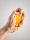 Man's Hand Squeezing an Orange Half Royalty Free Stock Photo