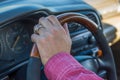 Man`s hand on the steering wheel inside of a car Royalty Free Stock Photo
