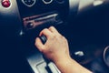 Man's hand switches automatic transmission closeup. Close up view of gear lever manual transmission car interior parts. Stylish T Royalty Free Stock Photo