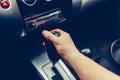 Man's hand switches automatic transmission closeup. Close up view of gear lever manual transmission car interior parts. Stylish T Royalty Free Stock Photo