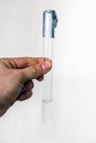 Man`s hand with a test tube with a nutrient medium based on agar