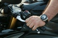 Man`s hand turned off the clutch on a motorcycle close up.