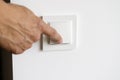 A man& x27;s hand turns on the light in the apartment Royalty Free Stock Photo