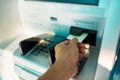 Man`s Hand Using Card To Withdraw Money