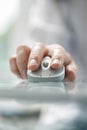 Man`s hand using cordless mouse on glass table.