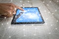 Man`s hand using tablet computer with world map and web communication connection on wooden desk Royalty Free Stock Photo