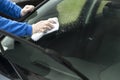 The man`s hand wipes the car`s glass with a cloth. Royalty Free Stock Photo