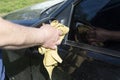 A man`s hand wipes a mirror in a car Royalty Free Stock Photo