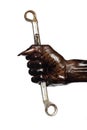 Man's Hand and Wrench in Engine Oil