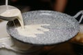 Man`s hands in black gloves cooking pancakes