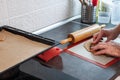 A man`s hands carve heart-shaped biscuits out of rolled dough Royalty Free Stock Photo