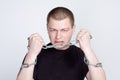 Man`s Hands in chain shackles on gray background Royalty Free Stock Photo
