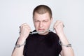 Man`s Hands in chain shackles on gray background Royalty Free Stock Photo