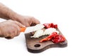 Man`s hands cutting pepper and onion with a ceramic knif Royalty Free Stock Photo