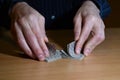 Man`s hands in darkness is shuffling set of playing cards, business strategic competition concept, closeup Royalty Free Stock Photo