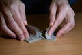 Man`s hands in darkness shuffling a set of playing cards, business strategic competition concept, closeup Royalty Free Stock Photo