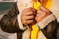 Man`s hands fastening a button on a yellow shirt Royalty Free Stock Photo