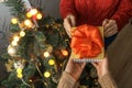 Man`s hands giving a Christmas gift to woman Royalty Free Stock Photo
