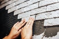 Facing wall decorative tiles, workers making brick wall Royalty Free Stock Photo