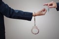 Man's hands in handcuffs and key Royalty Free Stock Photo