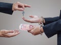 Man's hands in handcuffs and money in his palms Royalty Free Stock Photo