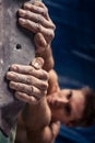 Man`s hands on handhold on artificial climbing wall Royalty Free Stock Photo