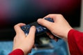 The man`s hands hold the console controller. Play video games at home. Hobbies in modern times Royalty Free Stock Photo