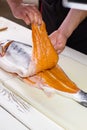 Man's hands hold fish meat.