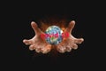 Man`s hands hold the globe on fire and lightning with the text covid-19 on a black background Royalty Free Stock Photo