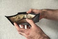 The man`s hands hold an open purse with one dollar Royalty Free Stock Photo