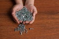 Man`s hands hold several screws. Royalty Free Stock Photo