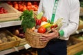 Man`s hands holding a basket of vegetables harvest in market Royalty Free Stock Photo