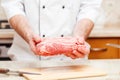 Man s hands holding beef piece, selective focus