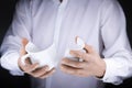 Man's hands holding a broken white mug