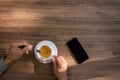 Man`s hands stirring tea in his desk on the table