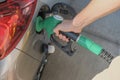 Man`s hands holding the gas pump and filling the car with fuel close-up. Energy industry. Gas station business/market. Royalty Free Stock Photo