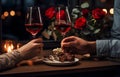 Man\'s hands holding hands of girl on restaurant table day light with two red wine glasses and red roses flower Royalty Free Stock Photo