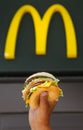 Man's hands, holding onto a burger