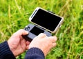 Man`s hands holding remote control  for launching a drone on a meadow Royalty Free Stock Photo