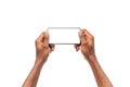 Man`s hands holding smartphone with blank screen, playing video games Royalty Free Stock Photo