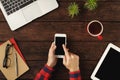 Man`s hands holding a smartphone, top view Royalty Free Stock Photo