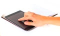 Man's hands are holding a tablet computer and points a finger
