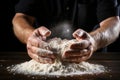 A man\'s hands knead the dough