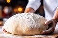 Man\'s hands knead dough for homemade goodness