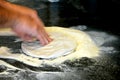 Man's hands kneading dough of pizza on the table