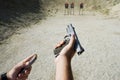 Man's Hands Loading Gun At Firing Range