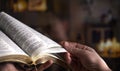 Man`s hands over the Bible, against the background of the living room