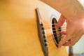 Man's hands playing acoustic guitar Royalty Free Stock Photo