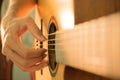 Man's hands playing acoustic guitar Royalty Free Stock Photo