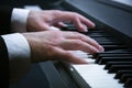 Man`s hands playing on a piano at the concert Royalty Free Stock Photo